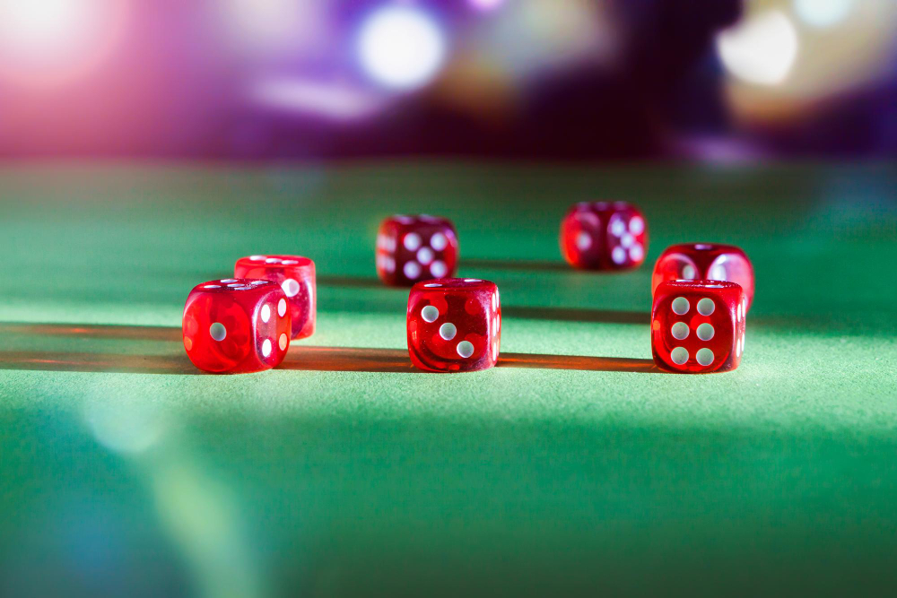 Red playing dice on a green cloth surface